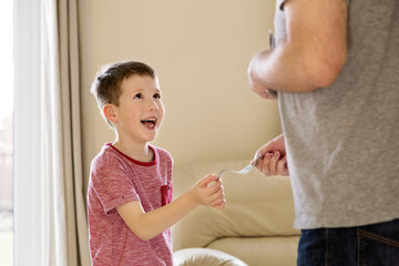 Boy receiving pocket money (allowance) from father