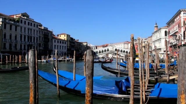 Gongolas on the waves on Rialto Bridge background, Venice