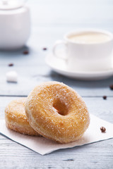 Fresh donut served with a cup of coffee