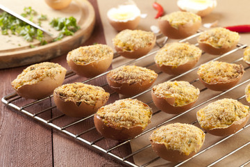 Baked eggs, stuffed with ham and parsley