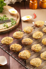 Baked eggs, stuffed with ham and parsley