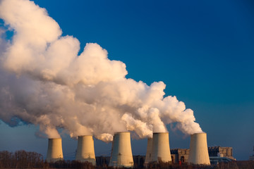 Smoking pipes of thermal power plant on sunset
