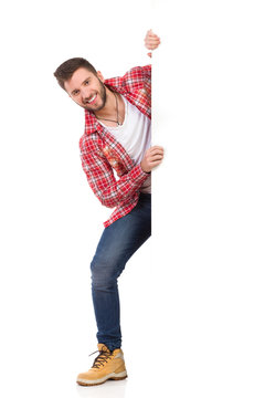 Smiling Man Jumping Out From Behind White Banner