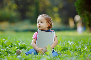 Child playing with tablet outdoors
