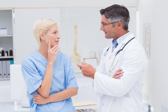 Doctor and nurse discussing in clinic
