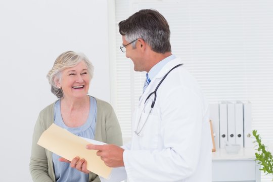 Doctor and patient conversing over reports