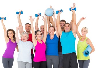 Fototapeta premium Excited people with exercise equipment raising hands