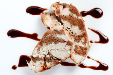 Chicken with balsamic sauce on a white background