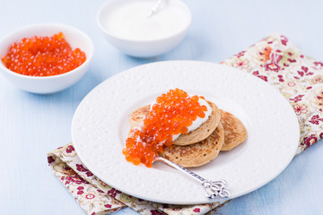 Buckwheat blini with red caviar and sour cream