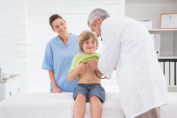 Doctor examining a little boy