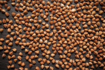 Buckwheat is sprinkled on black slate stone