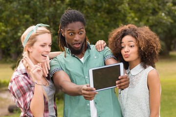 Happy friends in the park taking selfie