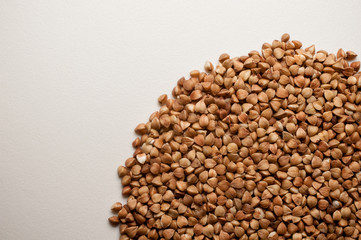 Buckwheat grains pile isolated on white background