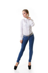 Fototapeta premium Attractive fashion girl in blue jeans and white shirt, full leng