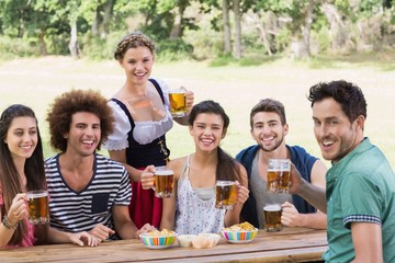 Pretty oktoberfest girl serving friends