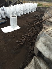 Coal pile, scale and bags filled with coal