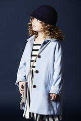 Fashionable girl in blue hat and coat