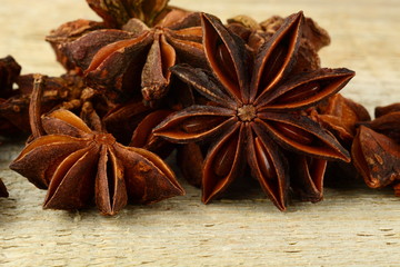 Macro view of many anise on wooden board
