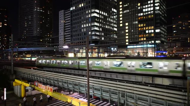 Train Passes over Bridge in Central Tokyo Japan at Night