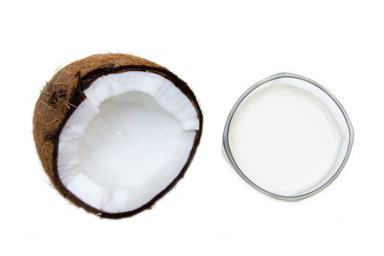 Glass with coconut milk on a white background seen from above
