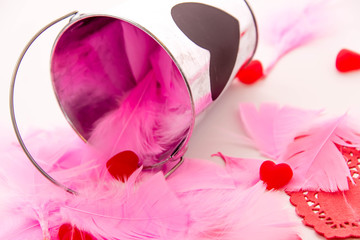 Valentines Day - decorations, pink feathers and heart shaped can