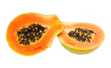 Fresh papaya cut in half on white background