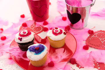 Valentines Day decorations and cupcakes with heart shaped frosti