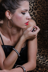 Obraz premium Sexy woman in studio, animal print fabric as background