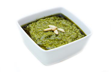 Pesto on square bowl on a white background