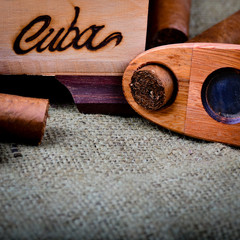 Cuban cigars with cutter on a hessian background
