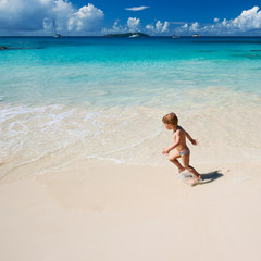 Fototapeta na wymiar Two year old boy playing on beach