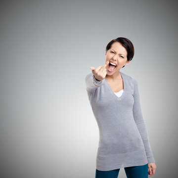Attractive woman shows a vulgar, obscene finger gesture