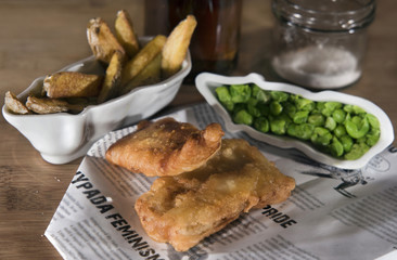 Fish and chips with mashed peas and vinegar