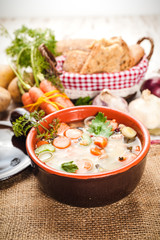 Rural vegetarian broth soup with colorful vegetables and rustic