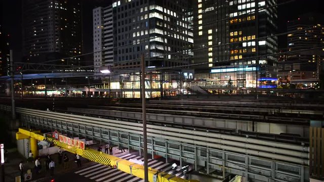 Time Lapse of Train Passing over Bridge in Central Tokyo Japan at Night