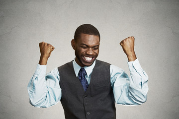 Successful businessman celebrates victory grey background 