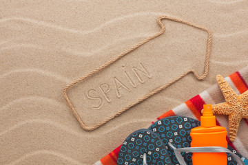 Fototapeta na wymiar Spain pointer and beach accessories lying on the sand