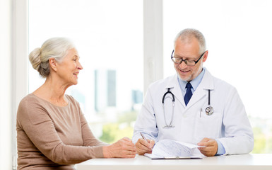 smiling senior woman and doctor meeting