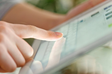Hand touching screen on modern digital tablet pc.