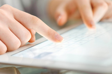 Hand touching screen on modern digital tablet pc.