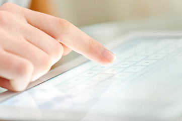 Hand touching screen on modern digital tablet pc.