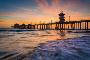 Waves in the Pacific Ocean and the pier at sunset, in Huntington