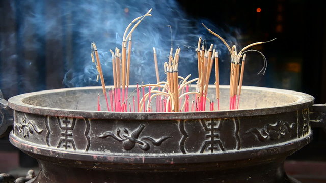 Incense Sticks Burning in Giant Pot in Front of Buddhist Temple 