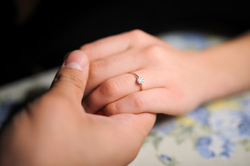 just engaged couple holding hands at restaurant