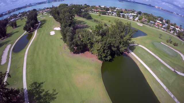 Aerial video of a golf course with luxury homes