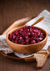 Russian beetroot salad in wooden bowl