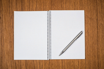 notepad with pen lying on the table