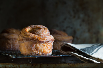 Fresh pastries on a cooling rack. Close up low key side light - 78917854