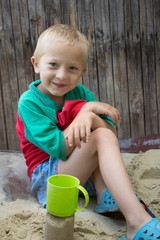 happy boy in sand