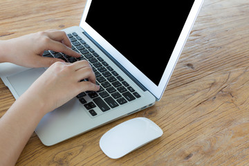 Closeup of business woman hand typing on laptop keyboard